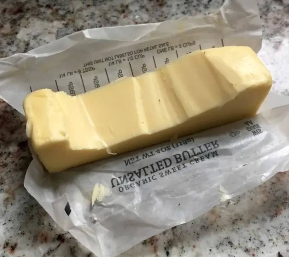 sitck of butter with segments jaggedly missing from top