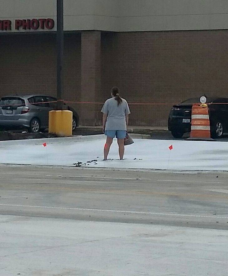 woman standing in wet cement
