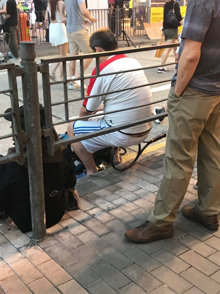 man squatting on tennis racket