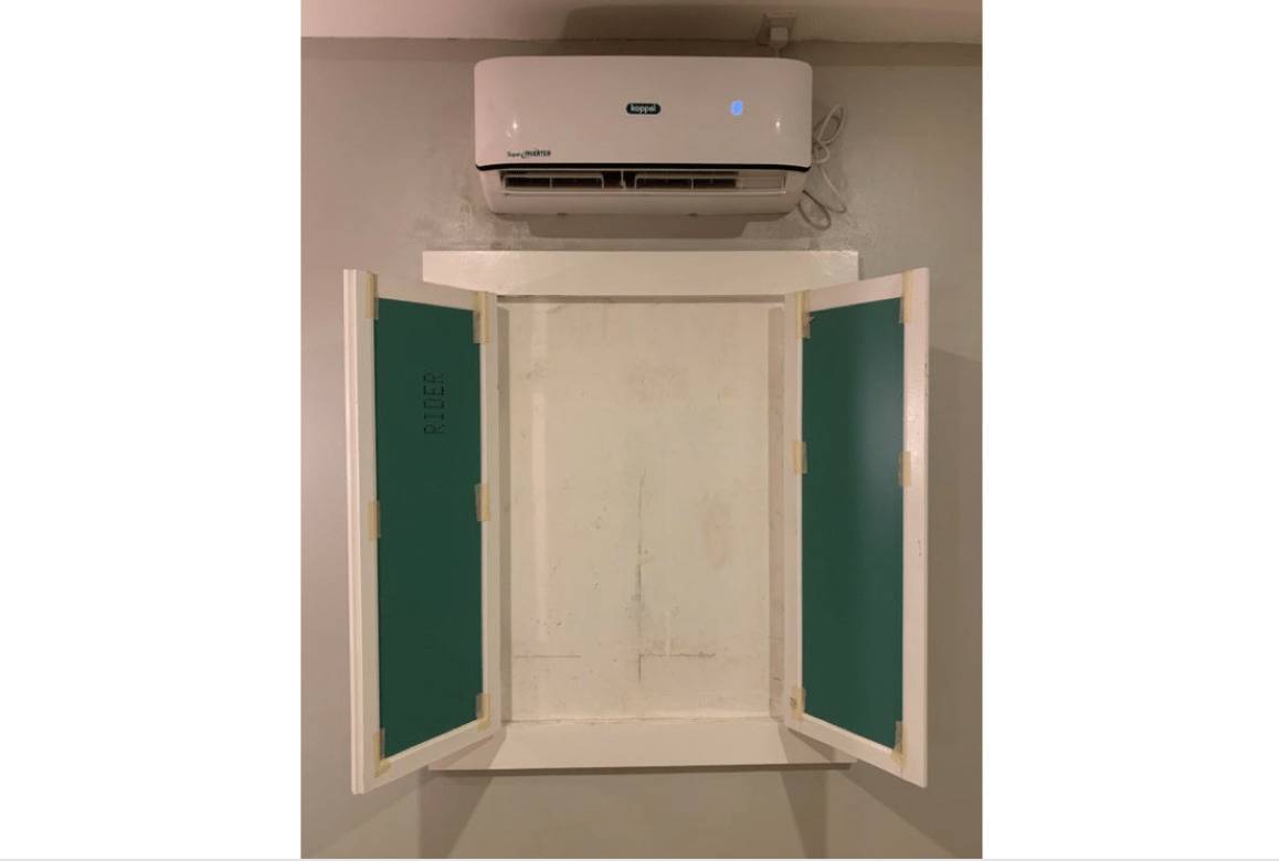 Window in hotel room opens up to a blank wall