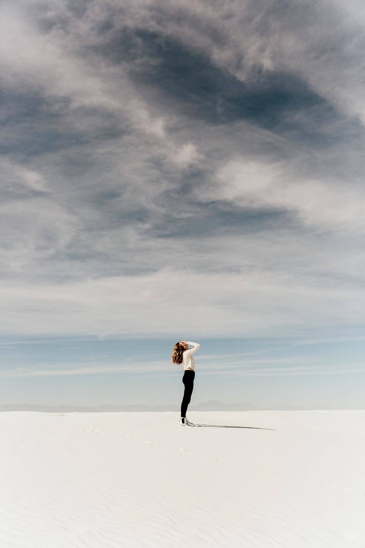 woman standing alone on sparse landscape
