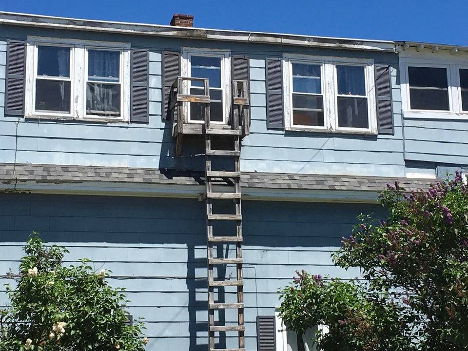 wooden fire escape at blue house