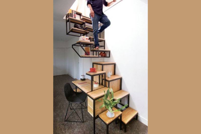 man coming down wooden shelved staircase