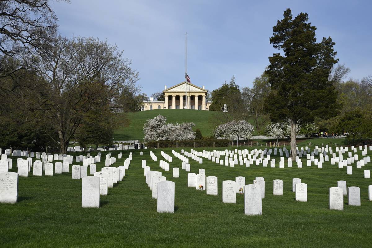 The graves of U.S. veterans and their spouses fill Arlington National Cemetery in front of the historic Arlington House.
