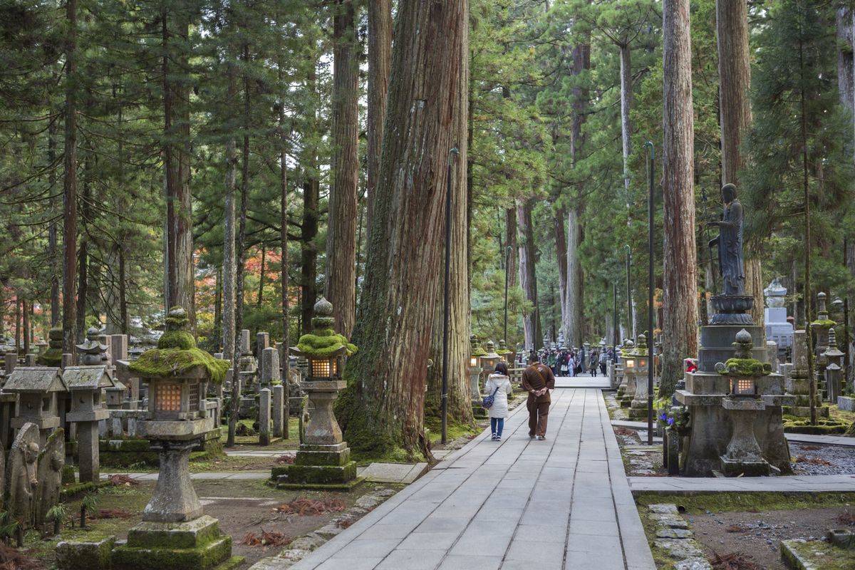 People walk through Okunoin Cemetary.