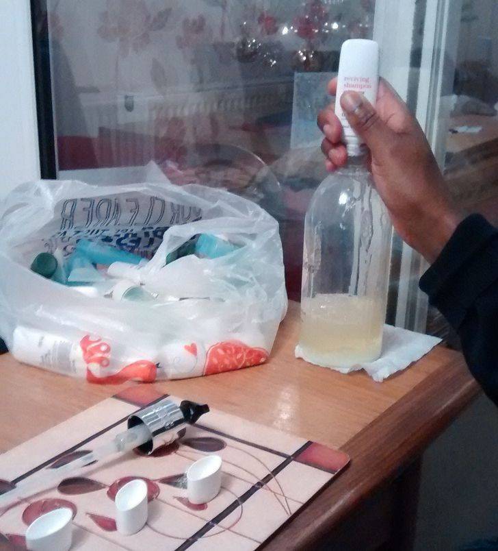 squeezing small shampoo bottles into bigger shampoo bottle
