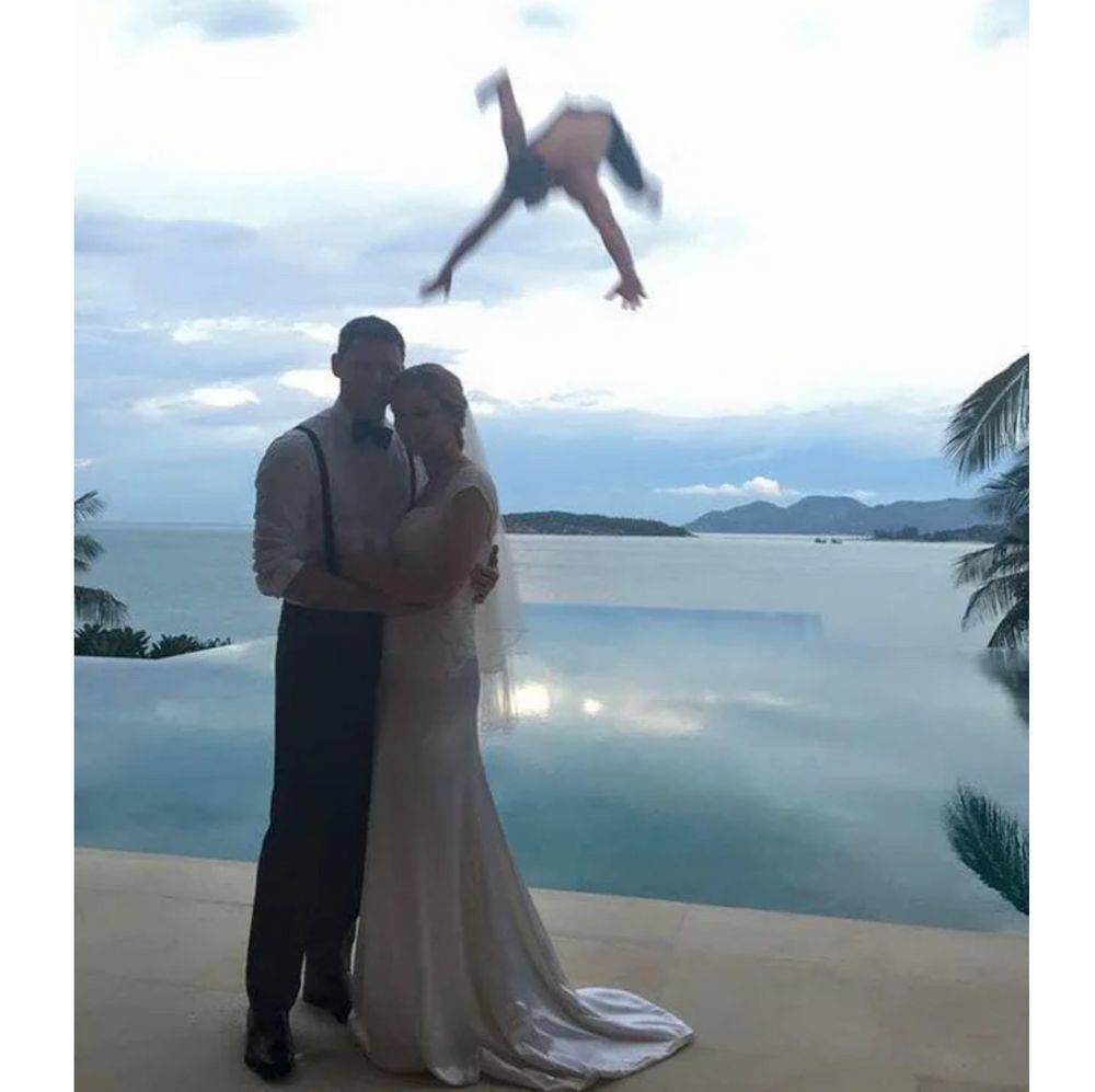 guy falling in background of wedding photo