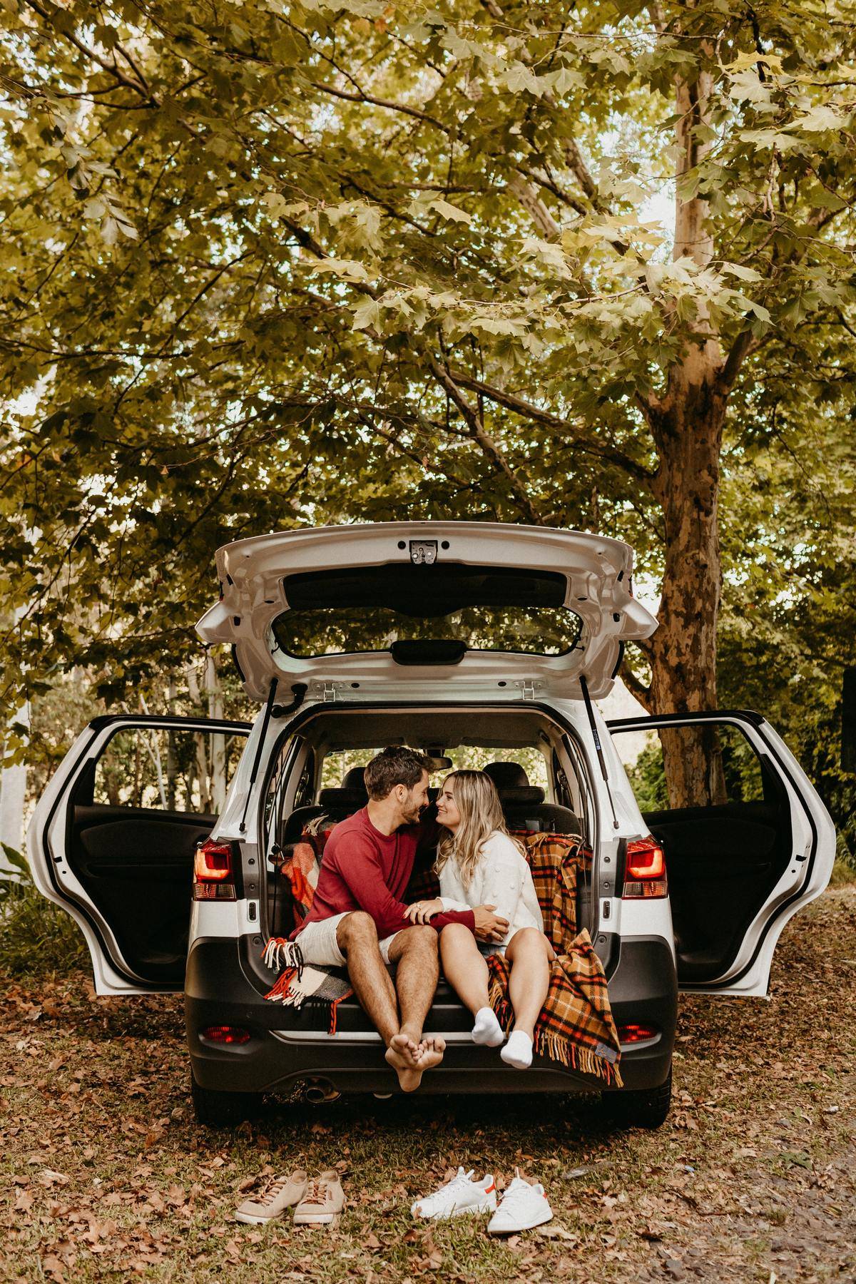 couple sitting in the truck of an suv