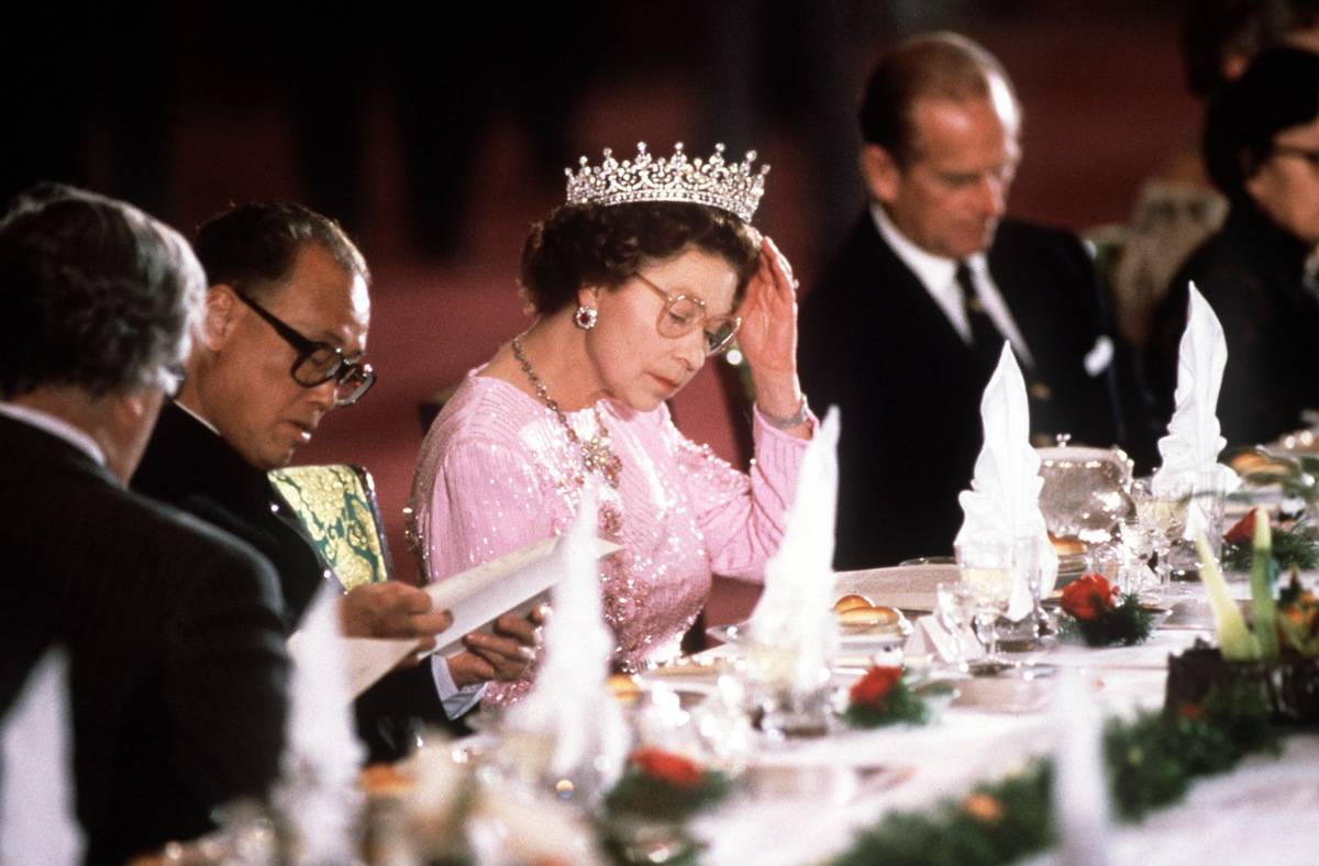 Queen Elizabeth II eats during a banquet.