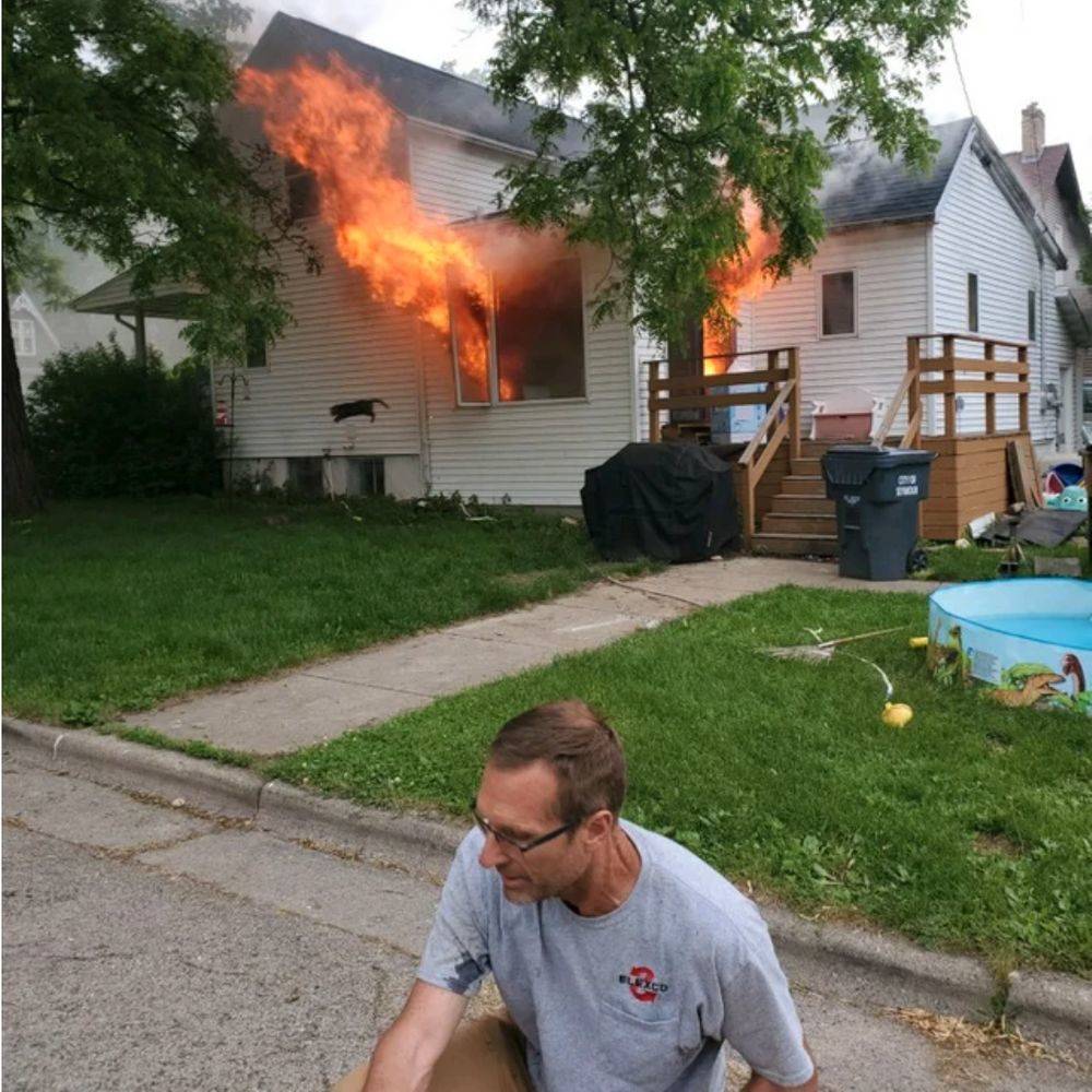 house on fire cat jumping out window