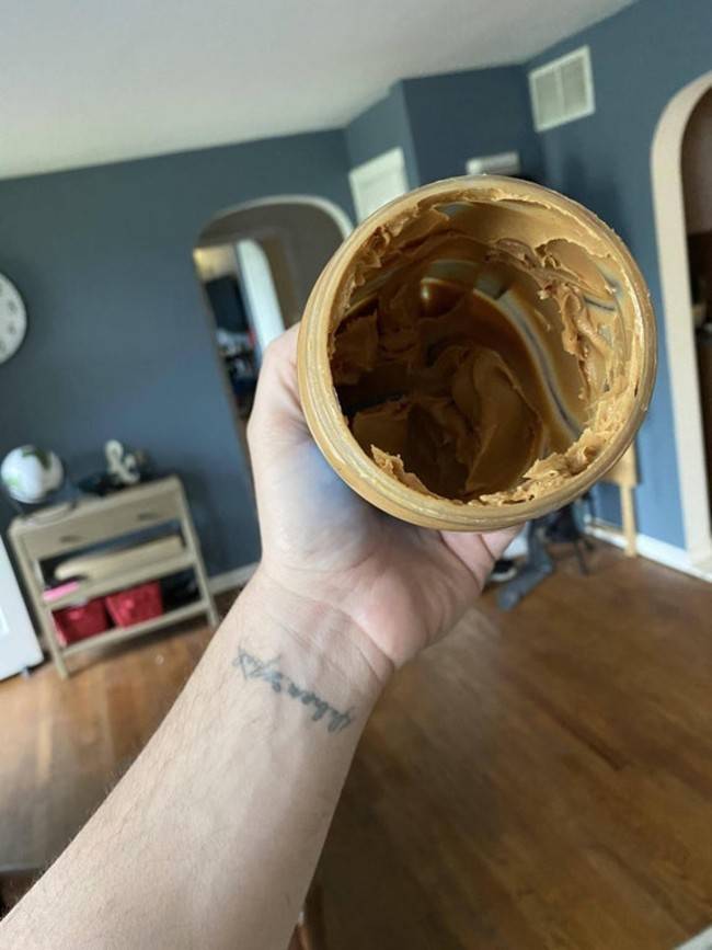 wife claiming peanut buter jar is empty so she was throwing it out but there's still tons left in the jar