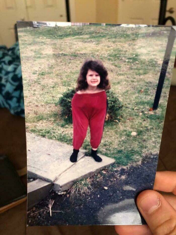 Kid wearing pants up to her shoulders