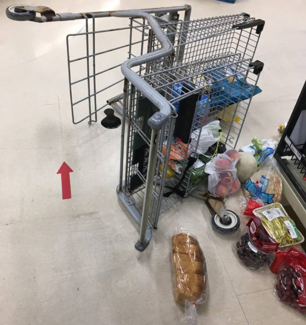 broken grocery cart with groceries all around it 
