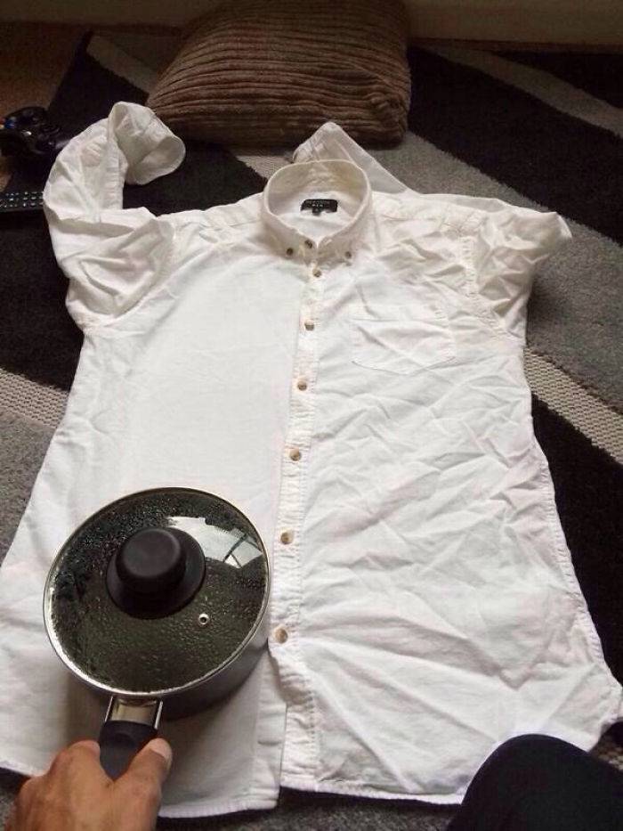 Shirt being ironed with hot pot of water