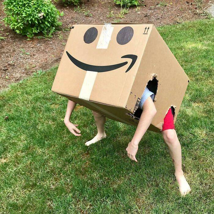 Kid inside amazon box with arm and leg holes