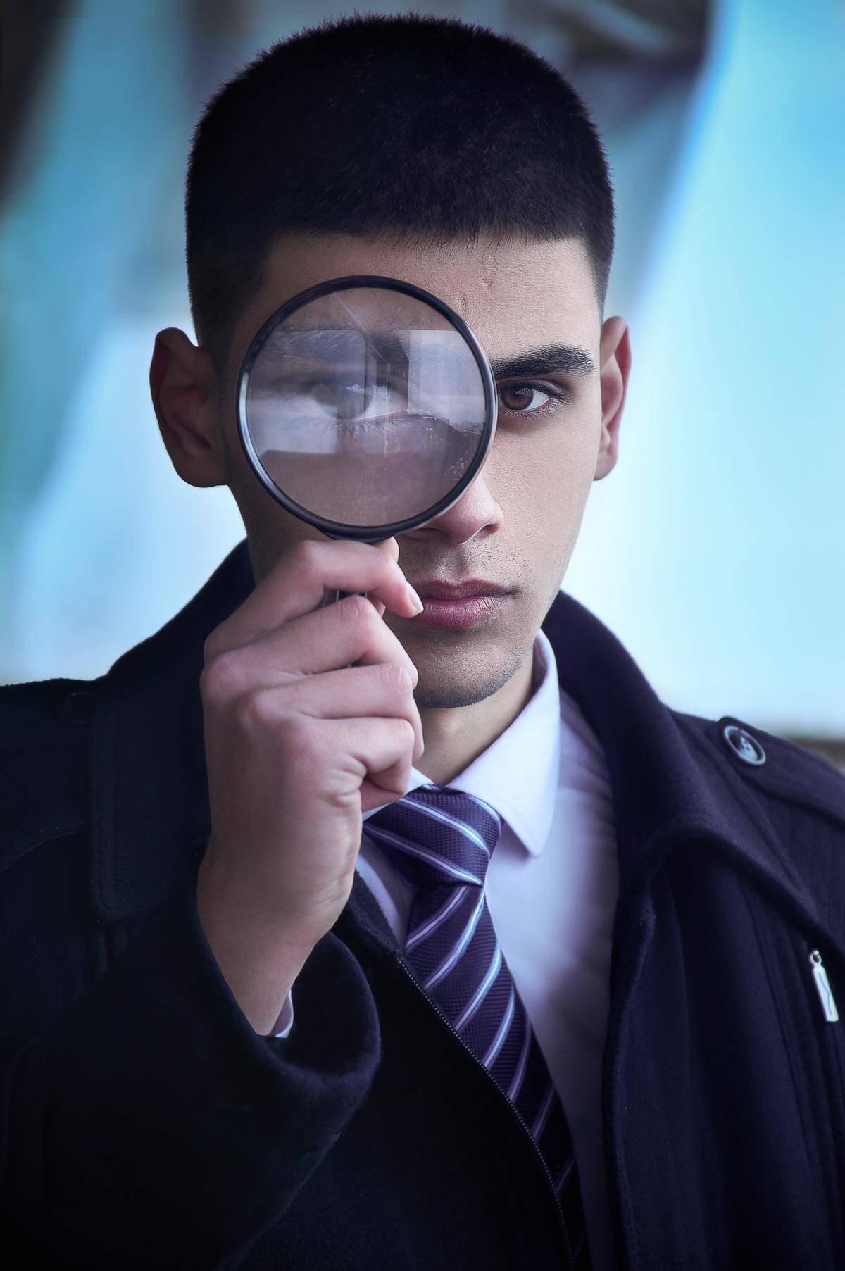 man with detective lens on his eye