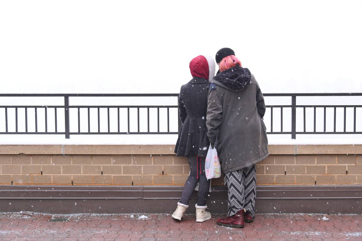 A couple view the shrouded Manhattan skyline from across the Hudson River on February 19, 2021 in Guttenberg, New Jersey