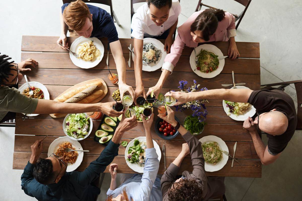 people sit around the table eating dinner