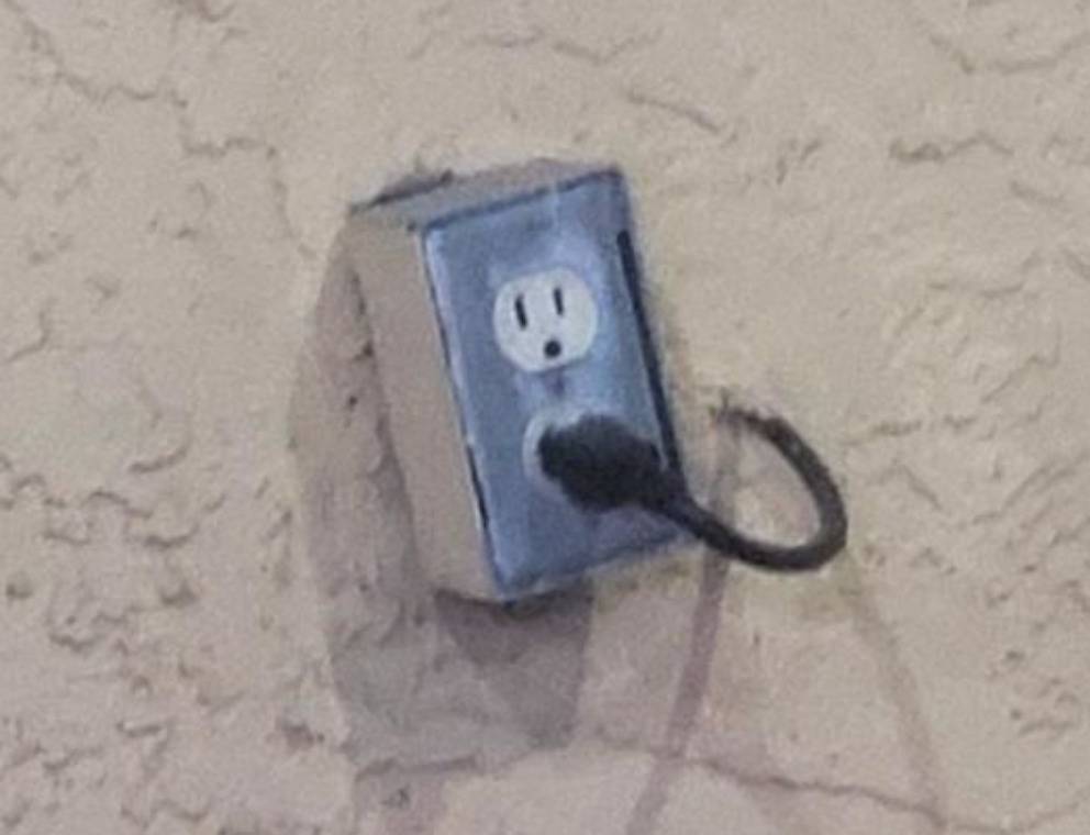 cord coming from the opposite side of the wall plugged into an outlet