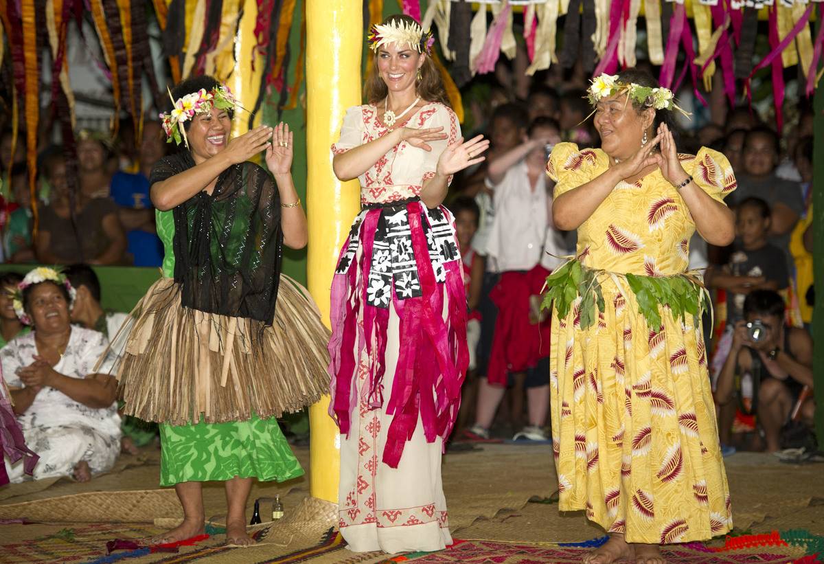 Kate Middleton dances with women during a ceremony the the royal tour of the Far East.