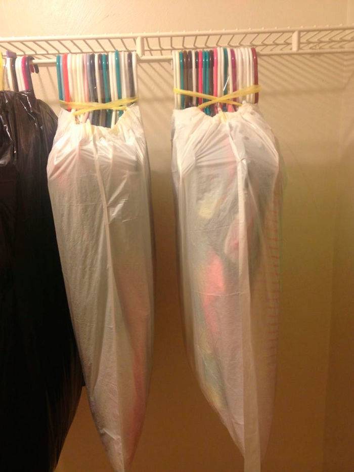 clothes on hangers in garbage bag