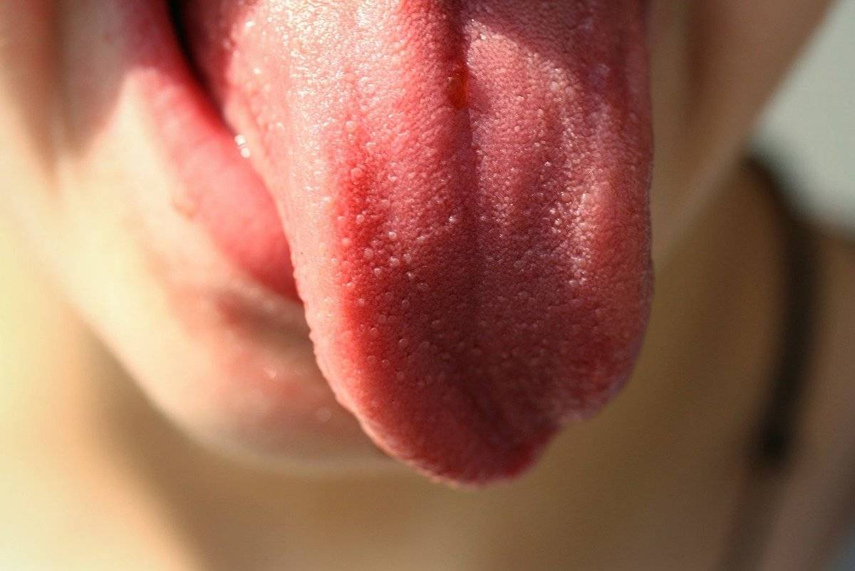 A person sticks her tongue out. 