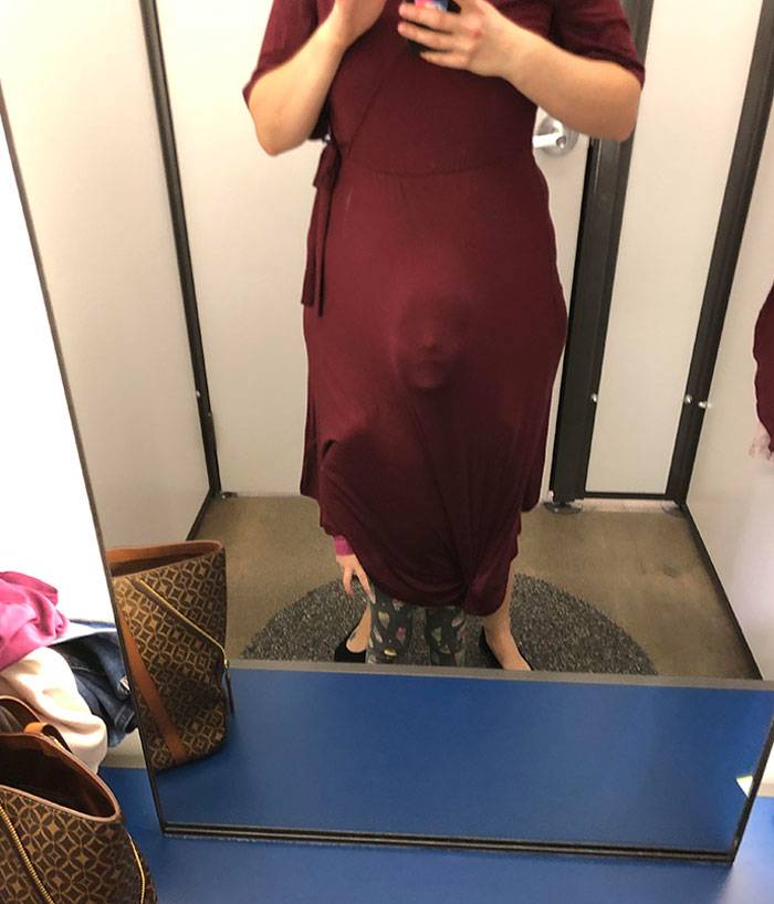 Kid under his mother's dress, pressing face against fabric, looking out