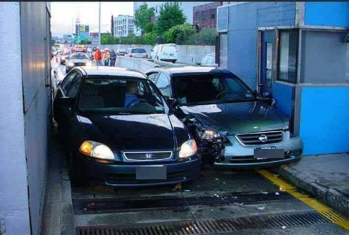 two cars going through toll gate that crashed together