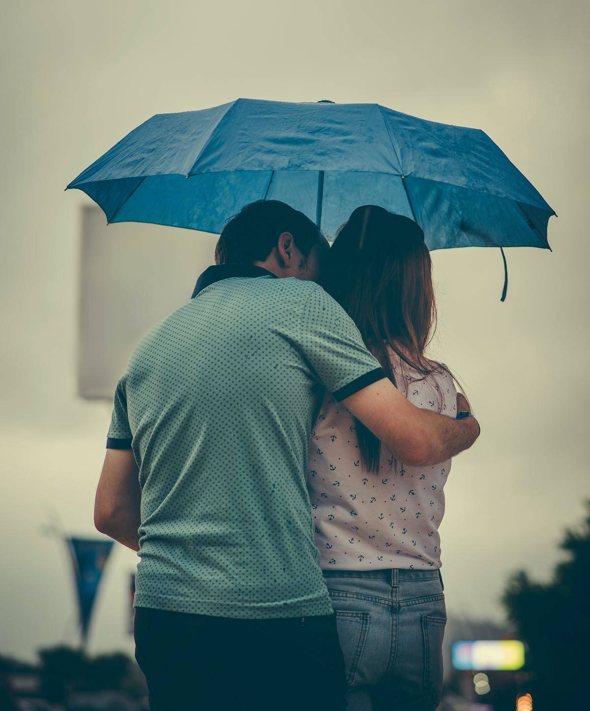 couple standing under an umbrella together