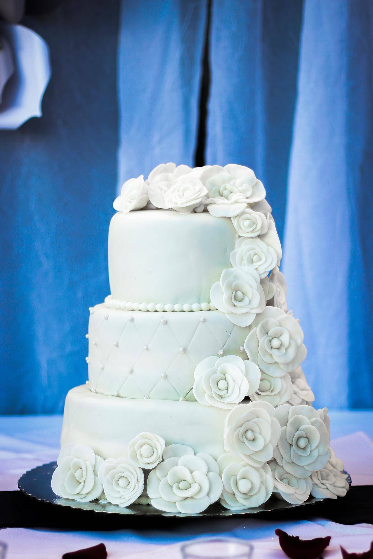 white wedding cake covered in flowers