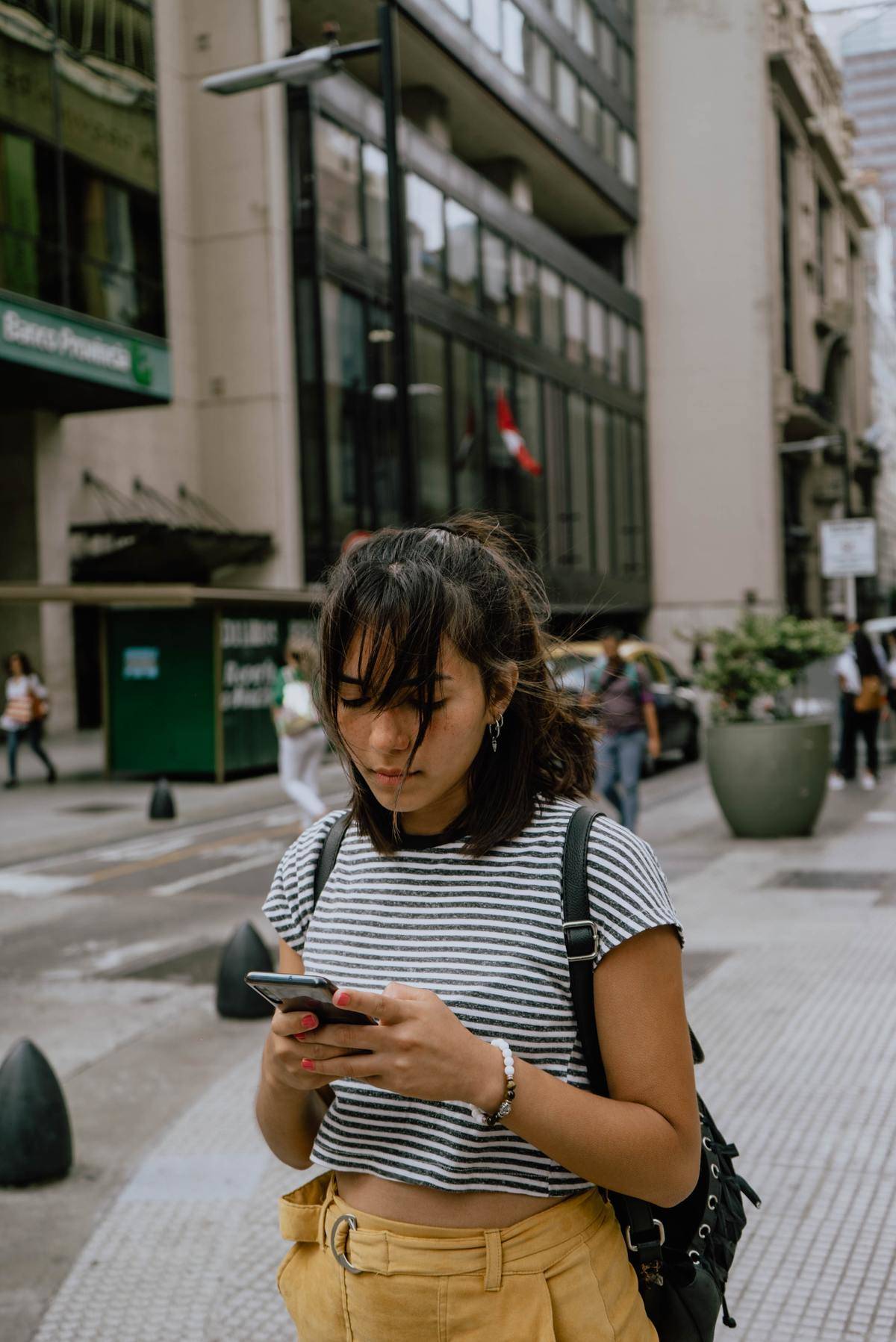a woman standing outside checking her phone