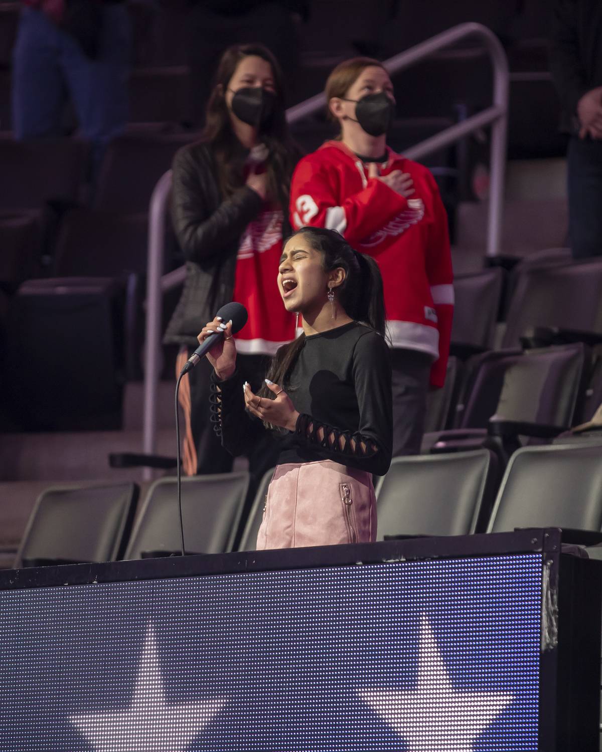 Srushti Gubbi sings the National Anthem prior to the start of an NHL game between the Columbus Blue Jackets and the Detroit Red Wings