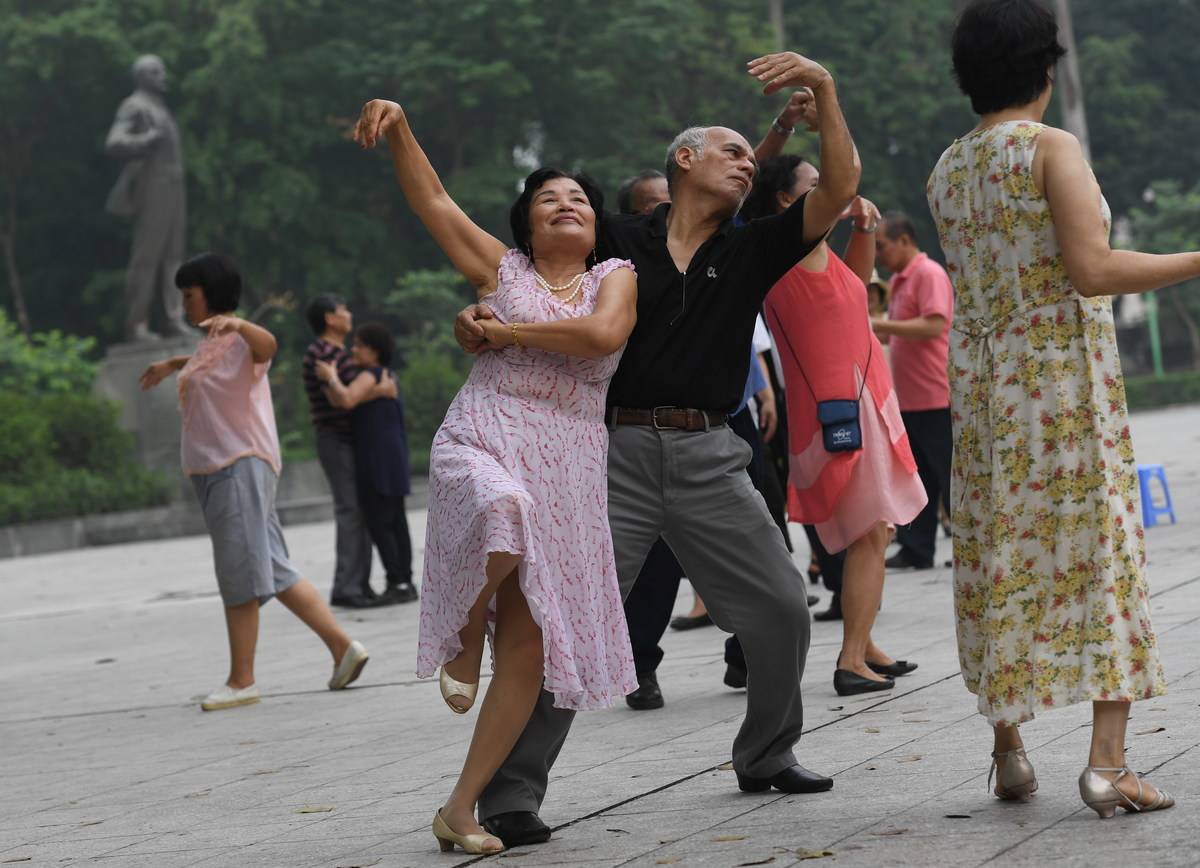 Older adults dance together as part of a dance club.