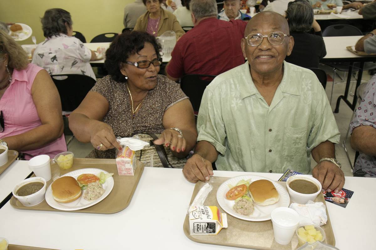 A couple eats lunch together at a community center.