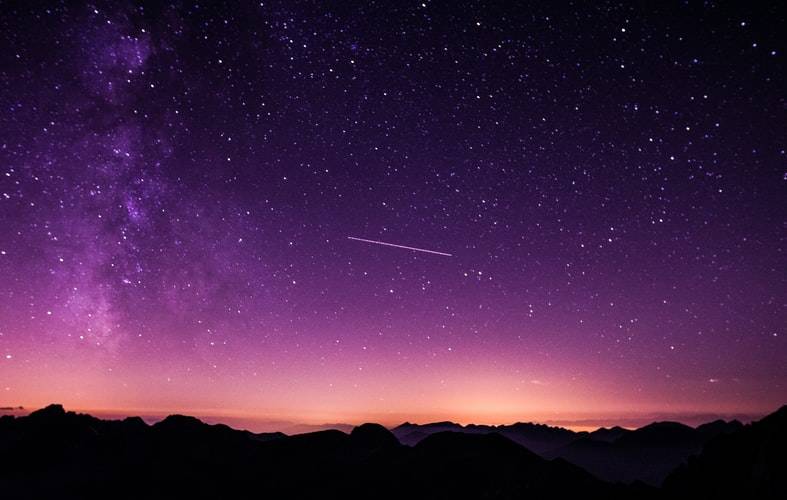 Sublime purple night sky with a shooting star in the middle