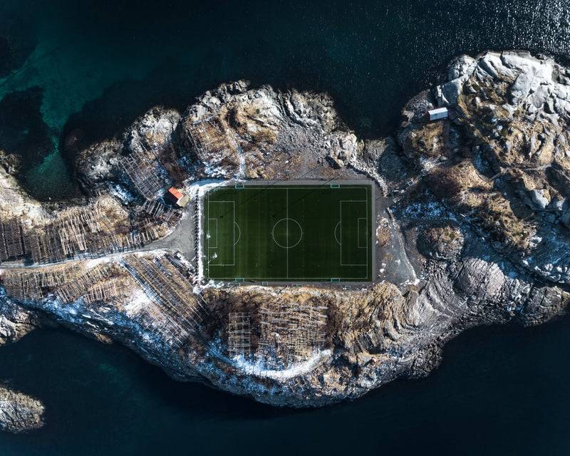 norway soccer field carved into island cliffs in the ocean