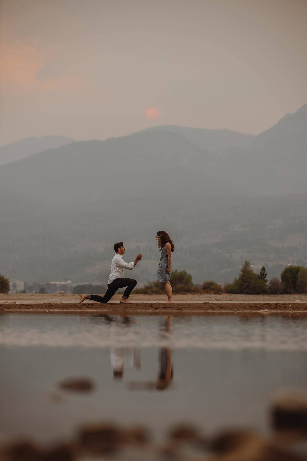 man on one knee proposing to woman