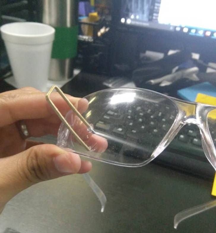 safety glasses with inch-long staple sticking out of them