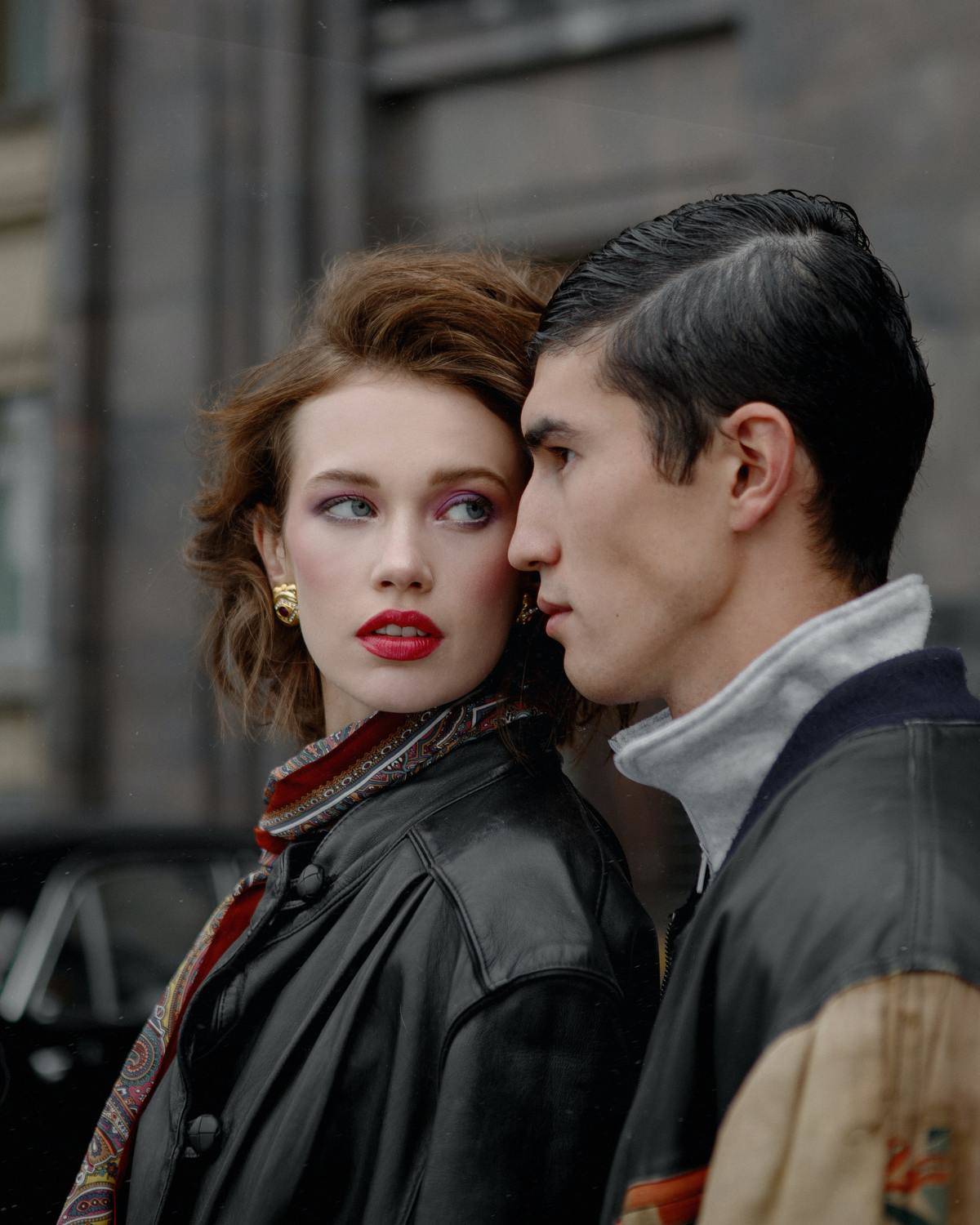 woman looking at man, both with serious expressions