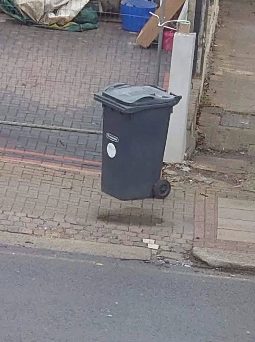 trash can next to water stain