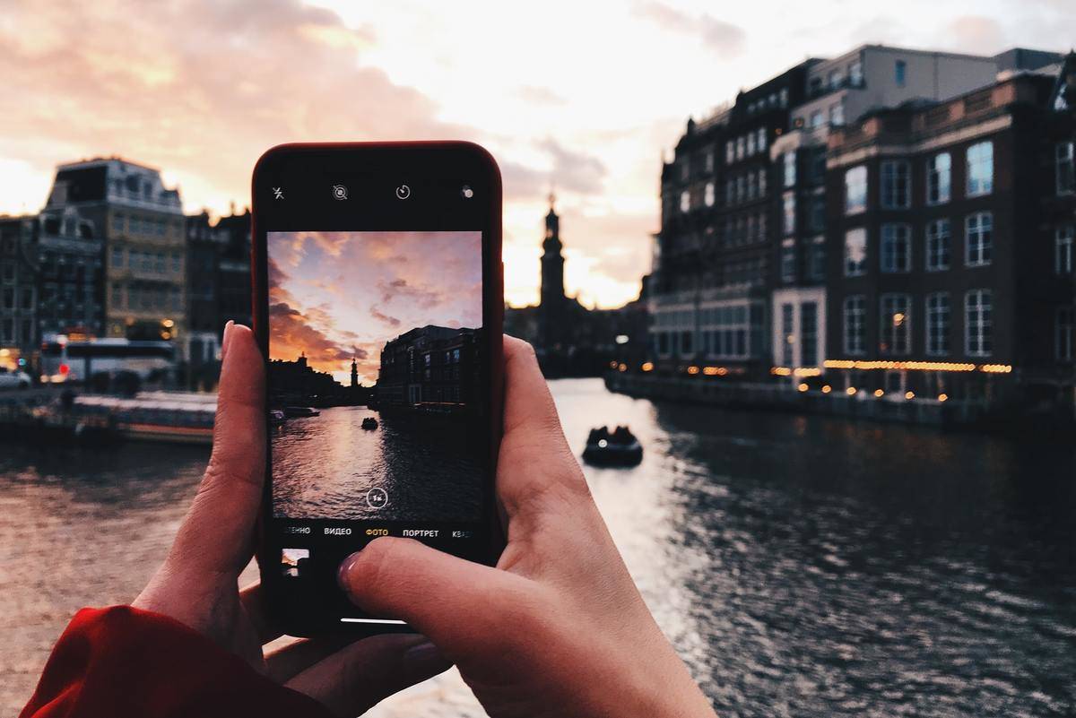 A tourist takes photos of Venice.