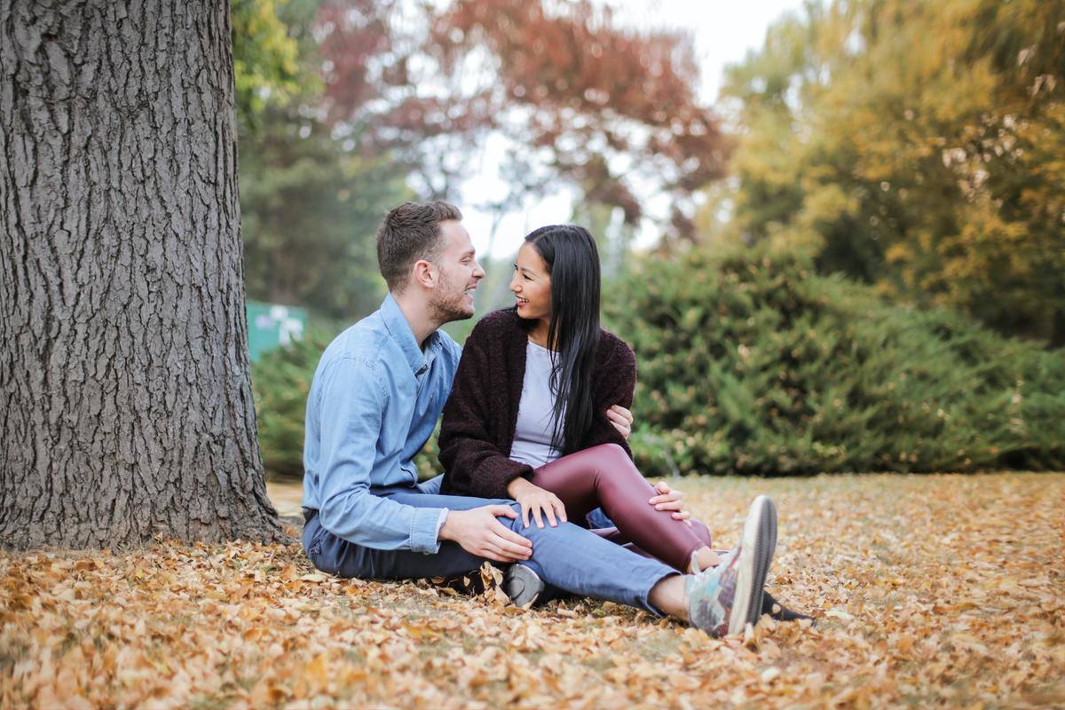 man and woman sitting in park and talking