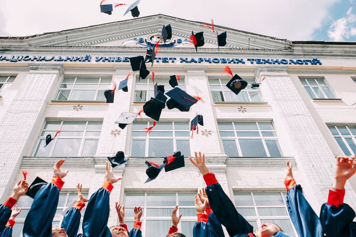 throwing graduation hats at ceremony