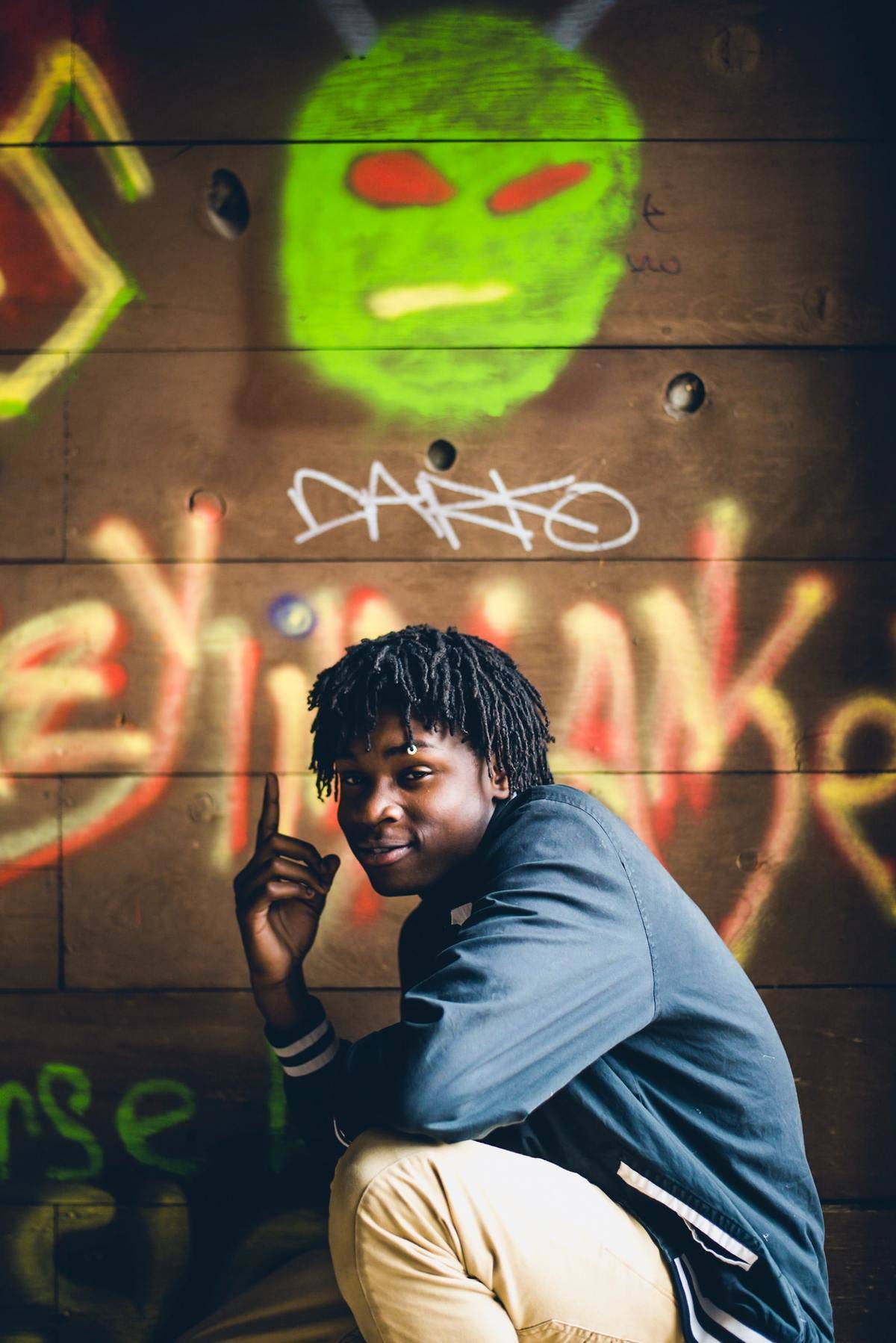 young man smiling and pointing up
