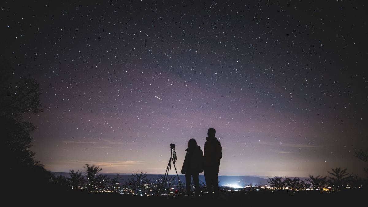 Couple looks at the stars in the sky