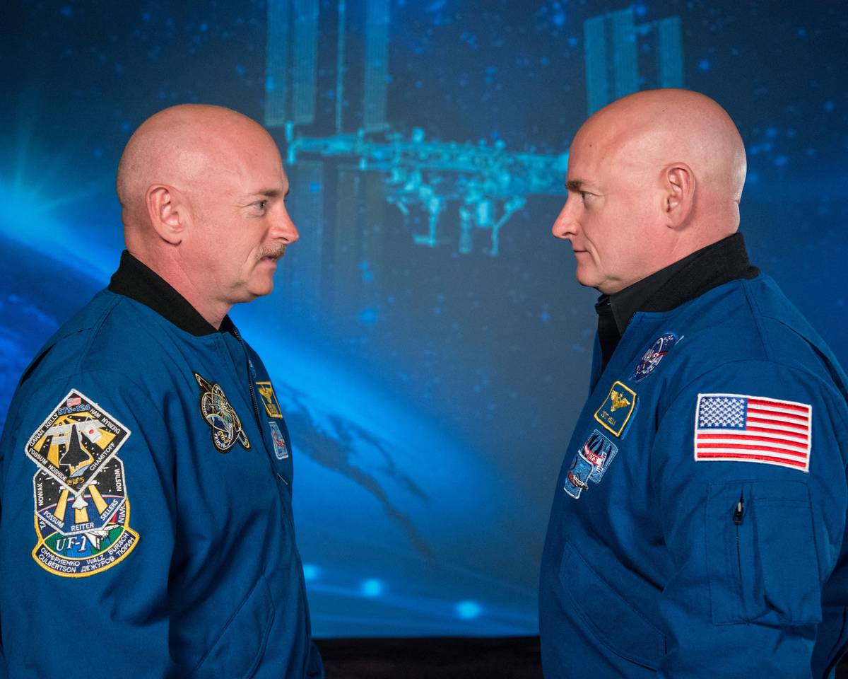 The Kelly twins face each other.