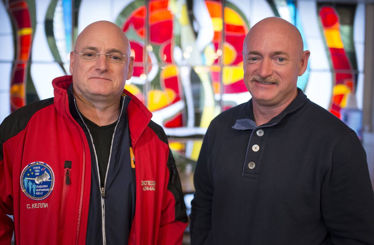 Mark Kelly (right) stands next to his twin brother, Scott Kelly.