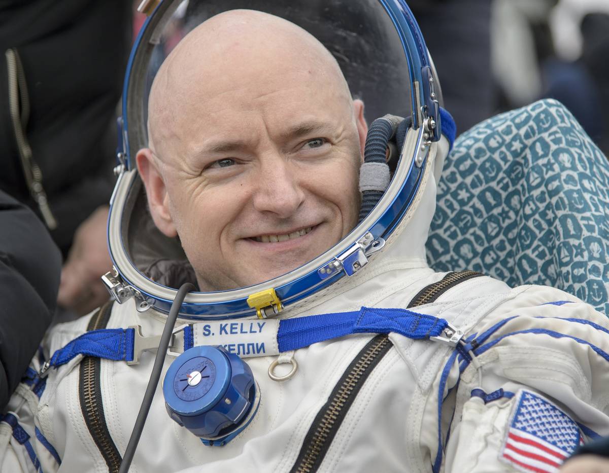 Captain Scott Kelly sits in his space suit outside the Soyuz TMA-18M spacecraft.
