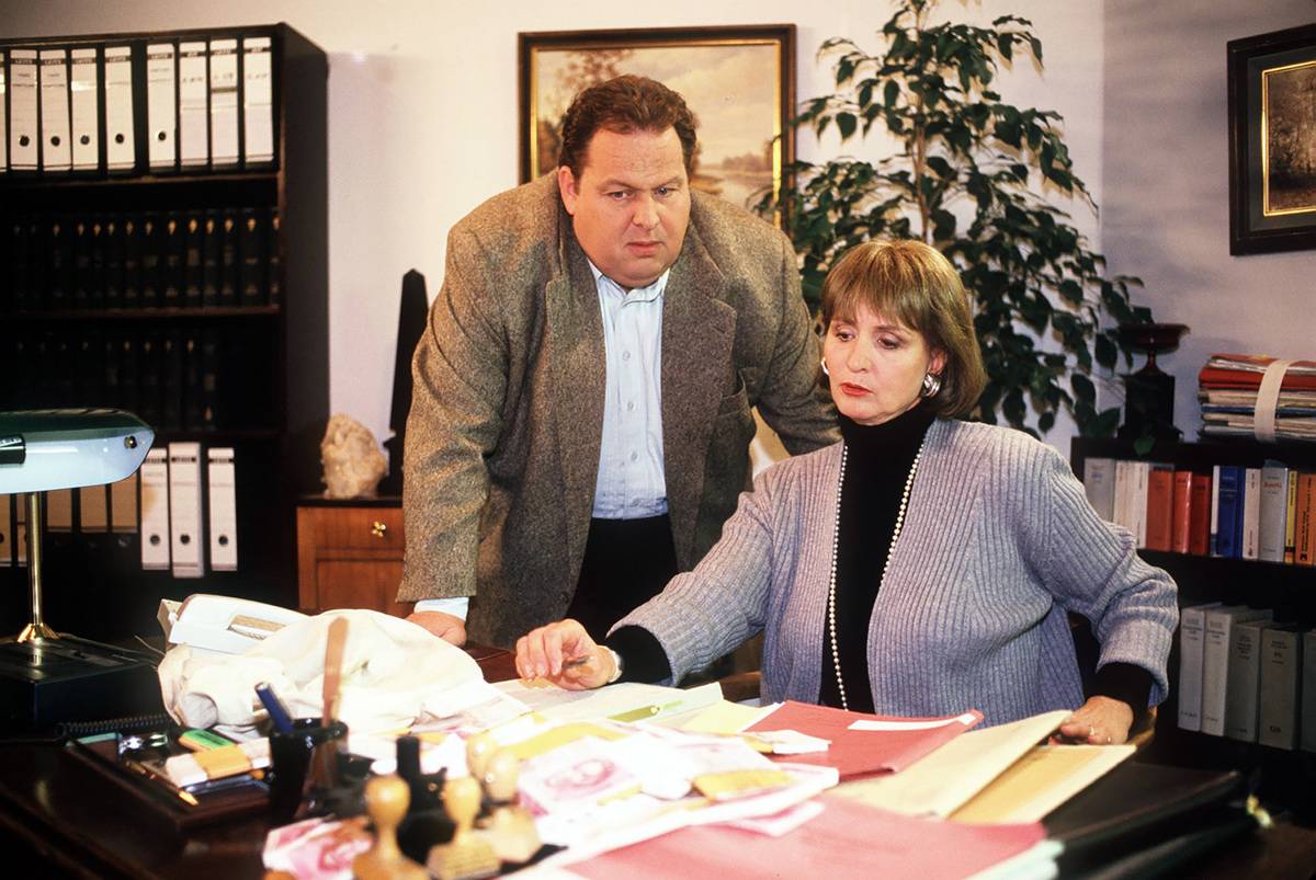 A financial advisor works with a woman on her budget.