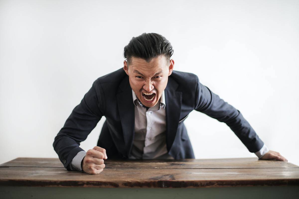 angry man slamming fist on table